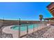 Fenced in pool surrounded by decorative rock and pavers, perfect for outdoor enjoyment at 1753 E Shasta St, Casa Grande, AZ 85122