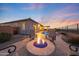 Spacious backyard features a stone fire pit, inviting pool, and relaxing patio, ideal for entertaining and enjoying serene views at 19051 N 259Th Ave, Buckeye, AZ 85396