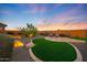 Serene backyard with turf and landscaping, offering a peaceful and beautifully designed outdoor retreat at 19051 N 259Th Ave, Buckeye, AZ 85396