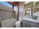 Stylish bathroom with tub, vanity, framed mirror and natural light at 19051 N 259Th Ave, Buckeye, AZ 85396