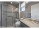 Modern bathroom with glass-enclosed shower, stylish tile accents, and vanity with sink at 19051 N 259Th Ave, Buckeye, AZ 85396