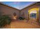 Inviting courtyard with a cozy bistro set, complemented by tasteful decor and serene landscaping at 19051 N 259Th Ave, Buckeye, AZ 85396