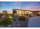 Beautiful home displaying desert landscaping with rocks, plants, and a stone walkway at 19051 N 259Th Ave, Buckeye, AZ 85396