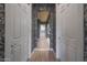 A bright hallway features decorative wallpaper, white trim, and wood-look flooring, providing a clean aesthetic at 19051 N 259Th Ave, Buckeye, AZ 85396