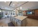 Open kitchen concept with island, stainless sink, marble countertop, and adjacent dining area at 19051 N 259Th Ave, Buckeye, AZ 85396