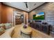 Comfortable seating area with brick accent wall, entertainment center and french doors at 19051 N 259Th Ave, Buckeye, AZ 85396