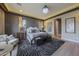 Stunning primary bedroom featuring decorative wallpaper, a unique light fixture and neutral-toned furnishings at 19051 N 259Th Ave, Buckeye, AZ 85396