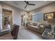 Inviting home office featuring neutral tones, wood-look floors, and a view to an en suite bathroom at 19051 N 259Th Ave, Buckeye, AZ 85396