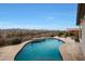 Inviting pool area with desert landscaping and scenic mountain views at 19051 N 259Th Ave, Buckeye, AZ 85396