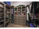 Spacious walk-in closet with wood-look shelving and drawers for organized storage and ample space at 19051 N 259Th Ave, Buckeye, AZ 85396