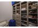 Well-organized closet boasting shelving and drawers for efficient storage, complete with a suitcase at 19051 N 259Th Ave, Buckeye, AZ 85396