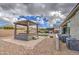 Landscaped backyard featuring a covered spa, outdoor kitchen and artificial grass at 19736 E Emperor Blvd, Queen Creek, AZ 85142