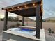 Backyard hot tub under a pergola with string lights, creating a relaxing outdoor space at 19736 E Emperor Blvd, Queen Creek, AZ 85142