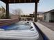 Backyard hot tub with pergola overlooking a firepit, outdoor kitchen, and seating at 19736 E Emperor Blvd, Queen Creek, AZ 85142