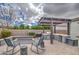 Backyard featuring an outdoor kitchen, fire pit, seating and green landscaping at 19736 E Emperor Blvd, Queen Creek, AZ 85142