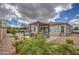 Spacious backyard with outdoor kitchen, fire pit, pergola and green landscaping at 19736 E Emperor Blvd, Queen Creek, AZ 85142