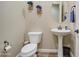 Powder room features pedestal sink, decorative fixtures, and neutral paint for a clean look at 19736 E Emperor Blvd, Queen Creek, AZ 85142