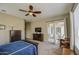 Bright bedroom with a ceiling fan leading out to a covered patio through sliding glass doors at 19736 E Emperor Blvd, Queen Creek, AZ 85142