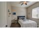 Cozy bedroom with neutral walls, ceiling fan, window with blinds, and artwork at 19736 E Emperor Blvd, Queen Creek, AZ 85142