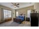 Comfortable bedroom features neutral paint, ceiling fan, and natural light from two windows at 19736 E Emperor Blvd, Queen Creek, AZ 85142