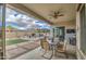 Covered patio overlooking backyard with outdoor kitchen, fire pit and pergola at 19736 E Emperor Blvd, Queen Creek, AZ 85142