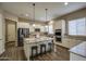 Bright kitchen featuring a large island with seating, stainless steel appliances, and wood flooring at 19736 E Emperor Blvd, Queen Creek, AZ 85142