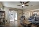 Spacious living room with tile floors flows out to the patio with seating through sliding glass door at 19736 E Emperor Blvd, Queen Creek, AZ 85142