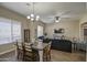 Open-concept living room and dining area with lots of natural light and wood-look tile floors at 19736 E Emperor Blvd, Queen Creek, AZ 85142