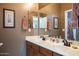 Inviting bathroom featuring double sinks with decorative accents and cabinetry at 203 S La Amador Trl, Casa Grande, AZ 85194