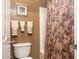 Cozy bathroom featuring a neutral tone, decorative floral shower curtain, and plush towels at 203 S La Amador Trl, Casa Grande, AZ 85194