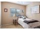 Cozy bedroom featuring natural light, decorative accents, and carpeted floors at 203 S La Amador Trl, Casa Grande, AZ 85194