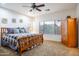 Serene bedroom featuring a ceiling fan, comfortable carpet, and plentiful natural light at 203 S La Amador Trl, Casa Grande, AZ 85194