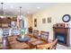 Bright dining area with a fireplace, an adjacent kitchen, and lots of natural light from many windows at 203 S La Amador Trl, Casa Grande, AZ 85194