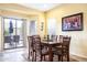 Cozy dining room with outdoor access and natural light coming through the sliding door to the patio at 203 S La Amador Trl, Casa Grande, AZ 85194