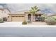 Charming single-story home featuring a desert-style front yard and stylish stone accents at the front entryway at 203 S La Amador Trl, Casa Grande, AZ 85194