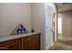 Inviting hallway with neutral tones, built-in cabinetry, and a patriotic display at 203 S La Amador Trl, Casa Grande, AZ 85194