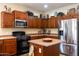 Functional kitchen with stainless steel appliances, ample cabinetry, and a kitchen island for food preparation at 203 S La Amador Trl, Casa Grande, AZ 85194