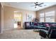 Cozy living room featuring neutral carpet, recessed lighting, ceiling fan, and archways to the other rooms at 203 S La Amador Trl, Casa Grande, AZ 85194