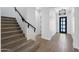 Bright entryway with tiled floors, staircase, modern light fixture, and paneling at 20979 E Mayberry Rd, Queen Creek, AZ 85142