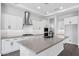 Modern kitchen with stainless steel appliances, an island with a sink, and stylish white cabinets at 20979 E Mayberry Rd, Queen Creek, AZ 85142