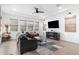 Bright living room featuring a ceiling fan and an entertainment center at 20979 E Mayberry Rd, Queen Creek, AZ 85142