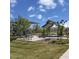 Community playground features picnic benches and seating areas with shade structures and mature trees at 21141 E Canary Way, Queen Creek, AZ 85142