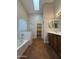 Bathroom showcasing a bathtub, shower, and dual sink vanity with tile floor at 2146 E Aloe Pl, Chandler, AZ 85286