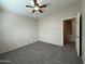 Bedroom featuring carpeted floors, ceiling fan, and a door leading to other parts of the house at 2146 E Aloe Pl, Chandler, AZ 85286