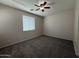 Bedroom with carpet flooring, ceiling fan, and a window providing natural light at 2146 E Aloe Pl, Chandler, AZ 85286