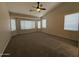 Spacious bedroom with carpet, ceiling fan and an array of large windows for natural light at 2146 E Aloe Pl, Chandler, AZ 85286