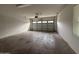 An empty garage space with a functional garage door for easy access, and lighting at 2146 E Aloe Pl, Chandler, AZ 85286