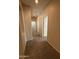 Hallway with carpet flooring and neutral walls leading to various rooms in the home at 2146 E Aloe Pl, Chandler, AZ 85286