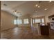 Spacious living room with tile floors open to the kitchen and breakfast nook at 2146 E Aloe Pl, Chandler, AZ 85286