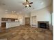 Open-concept layout of living room features a fireplace and seamless flow to the kitchen at 2146 E Aloe Pl, Chandler, AZ 85286